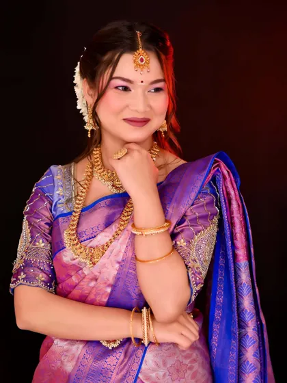 A candid moment capturing the bride's happy expression. The makeup is designed to look flawless from every angle, ensuring she is picture-perfect throughout her celebration.