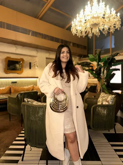 The contrast between the fuzzy coat and the sparkling dress is a great play on textures.