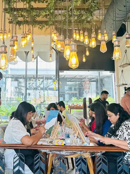 A wide shot of a workshop in a cafe with beautiful industrial-style lighting. The atmosphere of the venue plays a huge role in the overall experience.