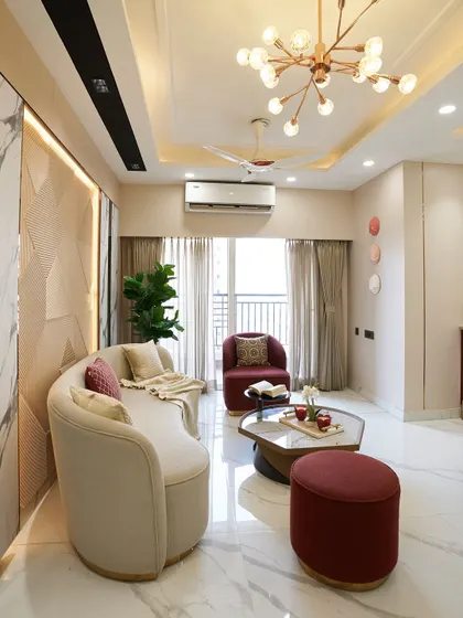 A wider view of the ACE Divino living room, showing the open layout and ample natural light. The combination of a curved sofa and a single armchair makes the space feel both spacious and cozy.