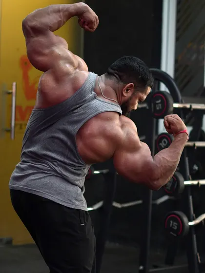A back double bicep pose in the gym.
