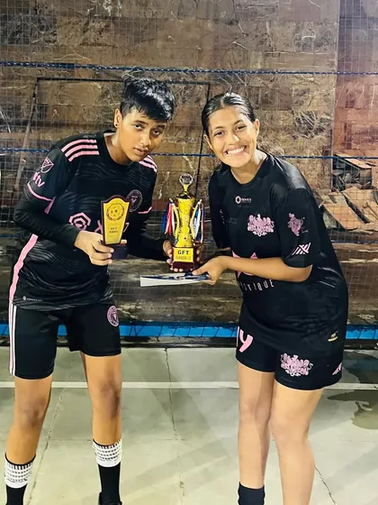 Two of our players proudly display the winner's trophy and the best player award from the Decathlon 4v4 tournament.