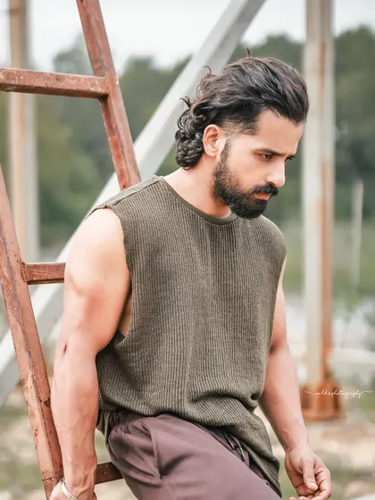 A series of portraits of actor Pruthvi Ambaar on location. These shots showcase a rugged, casual look against natural and industrial backdrops, highlighting his versatility.