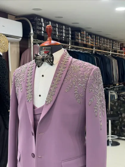 A close-up shot of the lavender tuxedo in my studio. You can see the quality of the fabric and the precision of the silver handwork that makes this piece so special.