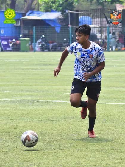 An action shot of our player driving the ball forward. Our training emphasizes proactive and attacking football.