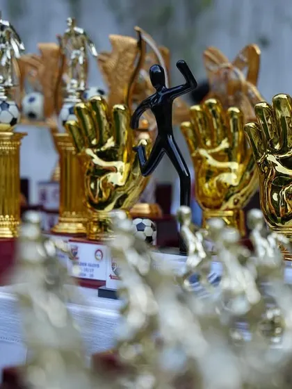 The trophies and awards lined up, ready to be presented at our 15th Year Celebration, honoring the hard work of our players.