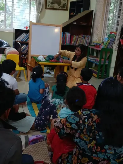 A storyteller uses yarn puppets to tell the story of the Three Little Pigs during our anniversary celebration.