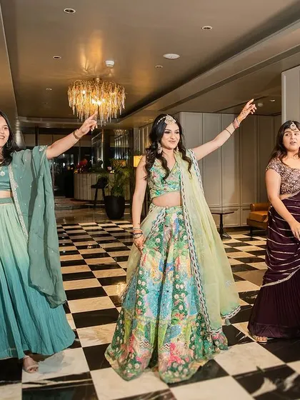 The bride and her best friends striking a pose. Group dances are all about having fun and celebrating the friendship that supports the bride on her big day.