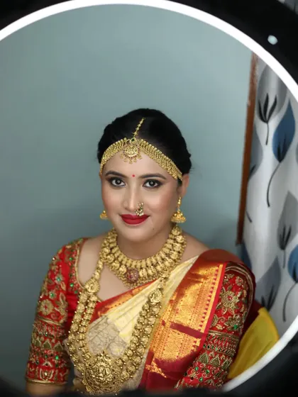 A ring-light portrait of the bride, highlighting her flawless makeup and the intricate details of her wedding jewellery.