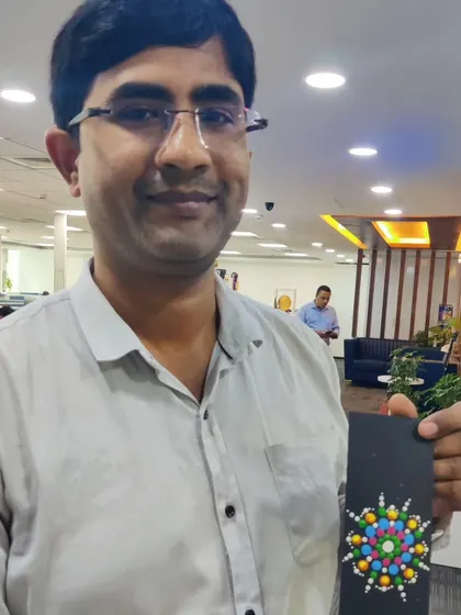 This employee proudly shows the intricate dot mandala he designed on a bookmark. These short, 20-minute art sessions are a proven way to introduce mindfulness and reduce stress during a busy workday.