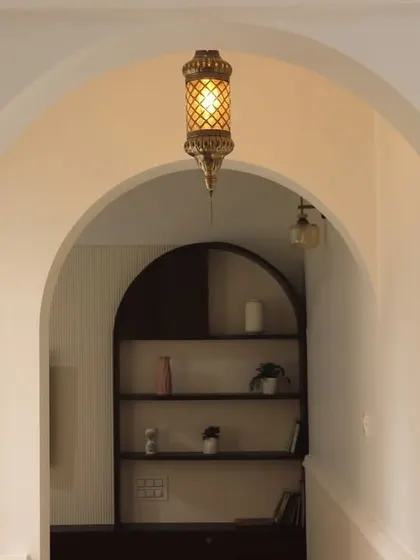 The finished archway, complete with a beautiful hanging lantern. This simple addition creates a portal-like entrance to the nook, proving that thoughtful architectural details can have a huge impact.