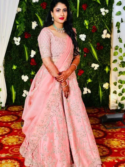 For another part of her ring ceremony, this bride wore a beautiful pink lehenga. I created a slightly more glamorous look with a bold red lip and defined eyes.