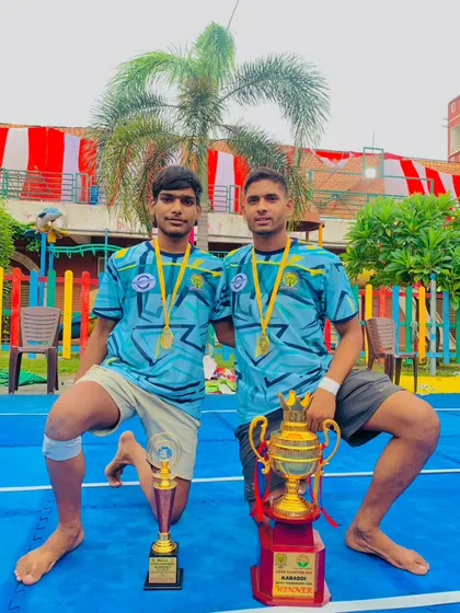 Two of our champion players with their trophies after a successful tournament.