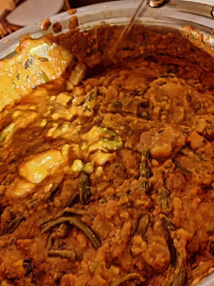 A close-up of a traditional Kutchi Memon curry being served at a Mehandi function. This hearty, vegetable-rich dish is a staple in our wedding catering menus.
