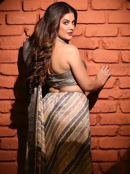 A back-profile shot from the same saree shoot, showcasing the design of the blouse and the drape of the fabric, which are important details for e-commerce fashion photography.