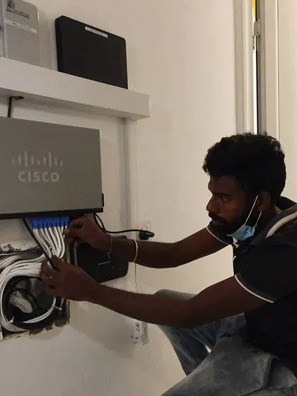 Here I am completing the wiring for a Cisco 24-port switch. I handle the full installation and programming for network equipment.
