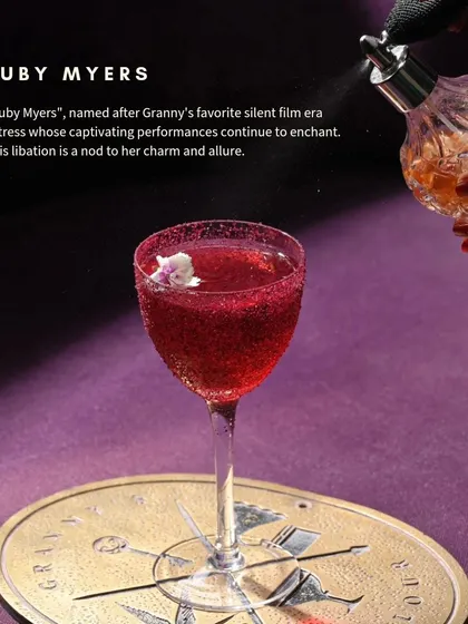 The Ruby Myers is named after a captivating silent film actress. This deep red libation, served in a coupe glass, is a nod to her timeless charm and allure.