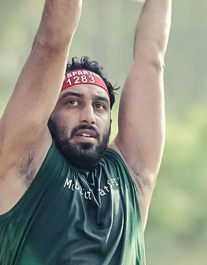 A close-up shot during an overhead lift at the Spartan Race. The intensity is written all on my face.