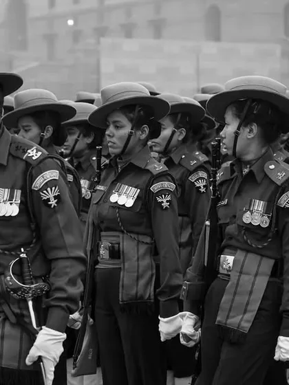 This black and white shot emphasizes the discipline and unity of the soldiers on a foggy Delhi morning. The lack of color draws attention to their expressions and the sharp lines of their formation during the parade rehearsal.