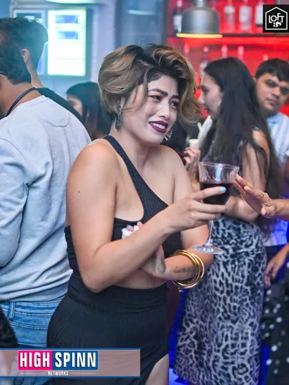 A guest enjoying a glass of wine and the music at Loft38.