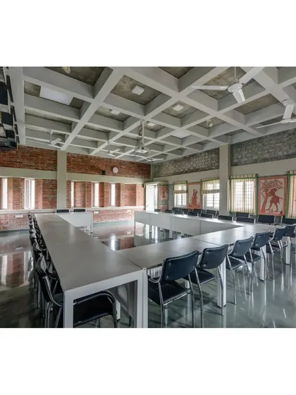 The large conference room at the ASA Office, featuring a coffered ceiling and exposed brick walls. The space is designed for large meetings and workshops, with ample natural light from the clerestory windows.