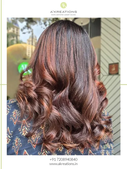 Another look at our rich balayage, showing the depth of color and the beautiful texture of the curls.