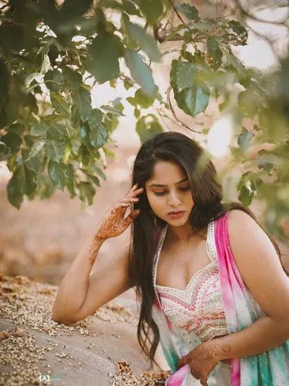 A slightly different angle from the same outdoor session, this shot captures a quiet, introspective moment. The natural textures of the surroundings add depth to the portrait.