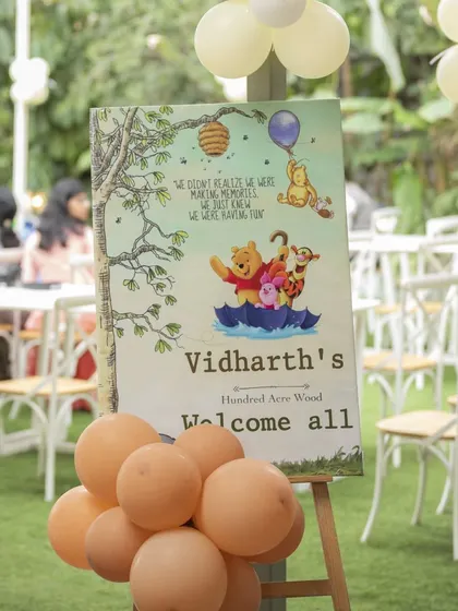 The welcome sign for Vidharth's 'Winnie the Pooh' party. The sign features a lovely quote and classic illustrations, creating a warm and inviting entrance.