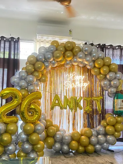 The full setup for the 26th birthday, including a champagne bottle foil balloon for a celebratory touch.