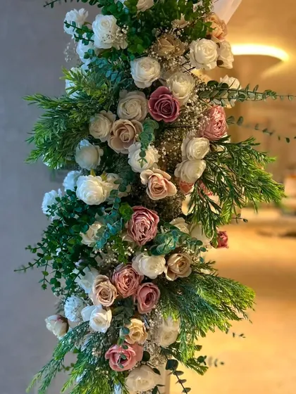 Another detail of the floral pillar for the welcome arch. The mix of eucalyptus and other greens adds depth and a fresh look to the housewarming flower arrangement.