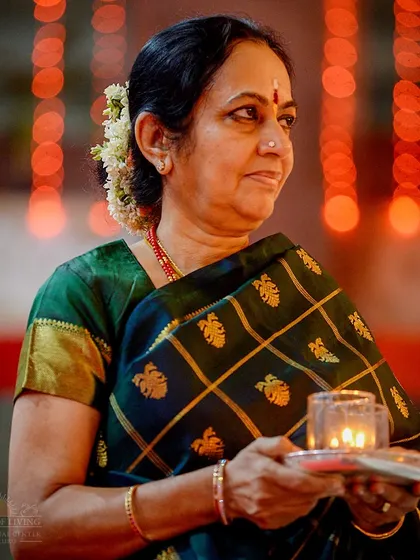 A woman holds a lamp during the first day's puja of Navratri. The simple act of offering light is a powerful prayer for knowledge and wisdom to dawn in our lives.
