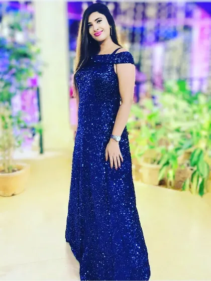Another look at the blue sequin gown, showing its elegant A-line silhouette. It's available in several other colors as well.