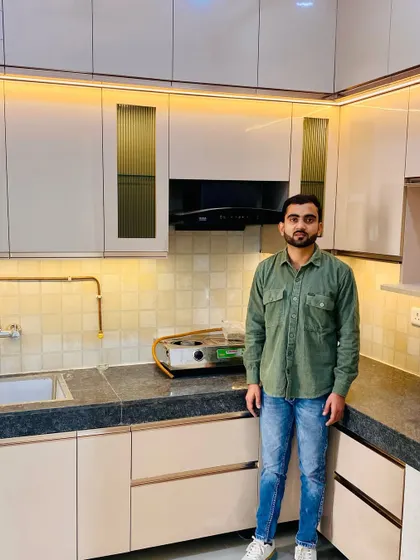 Me with another successfully completed kitchen project. This one features neutral-toned cabinets with fluted glass shutters and under-cabinet lighting.