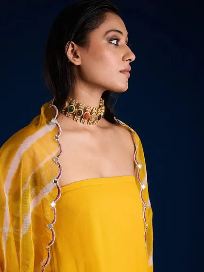 A close-up profile shot focusing on the jewelry and neckline details of the Aapro Alora Set.