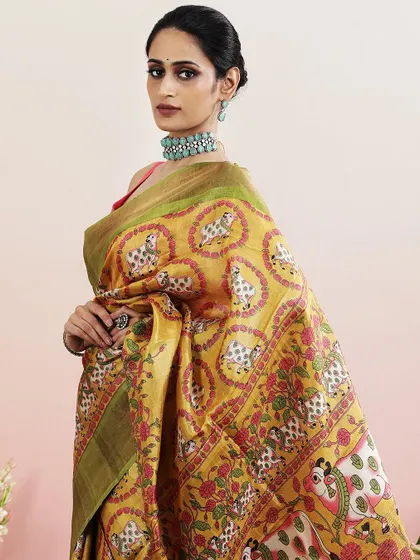 A close-up of the model wearing the Pichwai saree, paired with a statement choker.