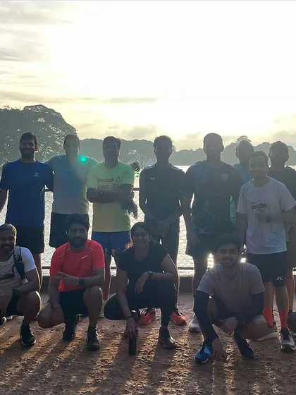 The team posing against the backdrop of a lake during a long run. We often explore different scenic routes in and around Bangalore.