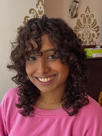 Saniya's smile says it all. This cut is all about embracing natural curls.