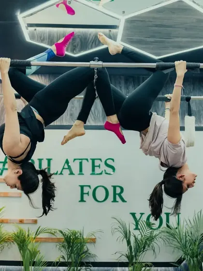 Working in pairs on the Trapeze Tower adds an element of trust and synchronization. This inverted pose is not only a great workout but also a beautiful expression of strength and balance.