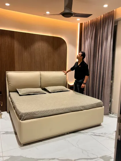 The full view of the bedroom shows how the curved wall paneling softens the room's lines.