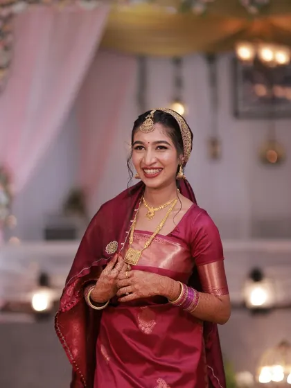 A candid moment of the bride. Her makeup looks flawless, and her smile is genuine.