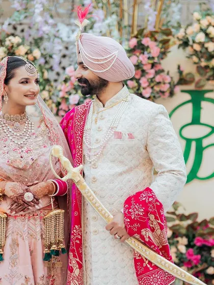 A closer look at the 'JB' monogram at this beautiful Amritsar wedding. The design becomes part of the couple's story as they share a quiet moment, with their unique emblem standing beside them.