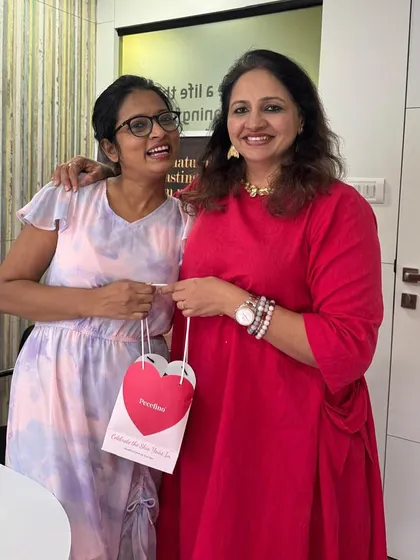 Handing a giveaway to a smiling client. The best part of my job is seeing the happiness and confidence that comes with healthy skin.