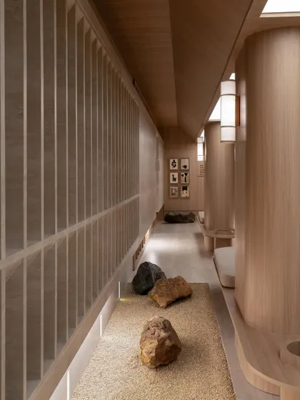 For a wellness brand, the architecture must breathe tranquility. I used a restrained palette of natural stone and warm wood, creating corridors that are not just passages but meditative pauses. The interplay of light, texture, and proportion guides a journey of calm.