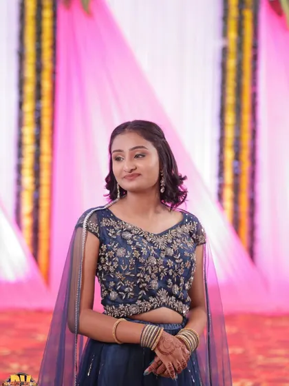 A poised shot of the client in the navy blue lehenga, looking beautiful and confident.