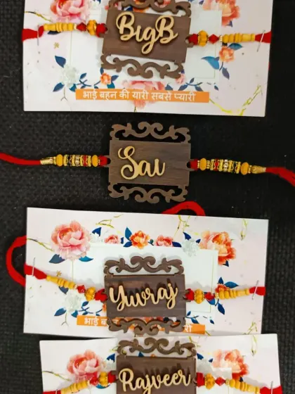 These laser-cut wooden rakhis have an intricate design and can be personalized with names or nicknames like "Big B".