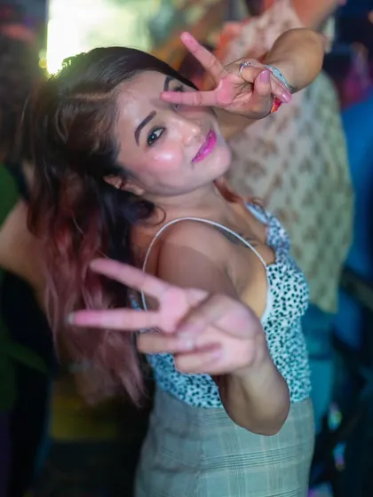 A guest making a peace sign, capturing the fun and friendly vibe.