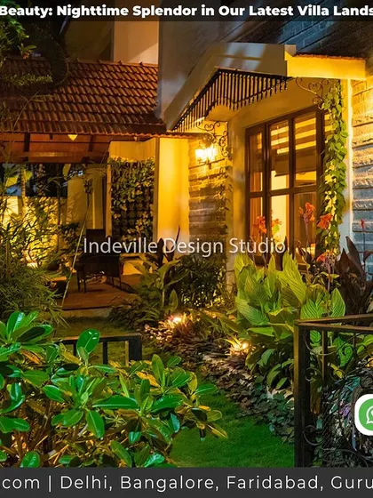 A side view of the villa at night, showing how landscape lighting along the wall and under the eaves adds depth and security.