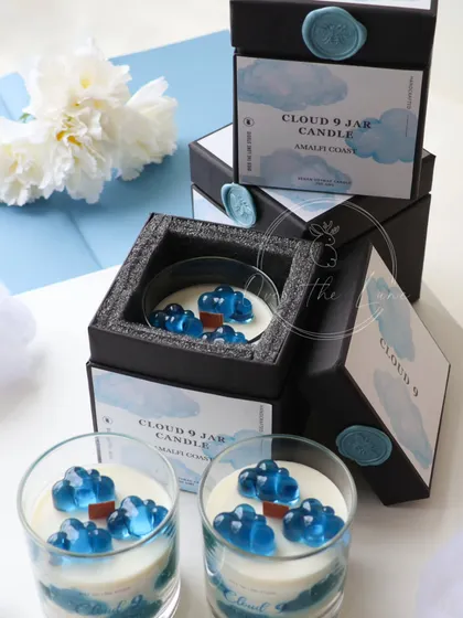 For the dreamers, I created the 'Cloud 9' jar candle. This limited edition piece features gel wax clouds floating in a soy wax sky, all beautifully presented in a custom-designed box with a wax seal.