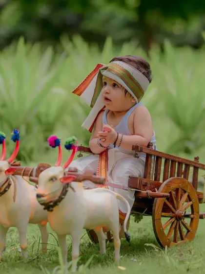 A moment of quiet contemplation for this little farmer. The details, from the turban to his tiny hands, are what make these cultural photoshoots so special and authentic.
