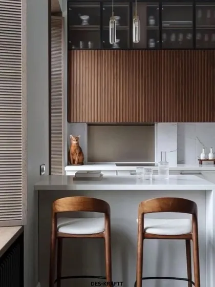A closer look at the breakfast bar area, featuring comfortable wooden stools and louvered window shutters that add a touch of classic charm to the contemporary space.